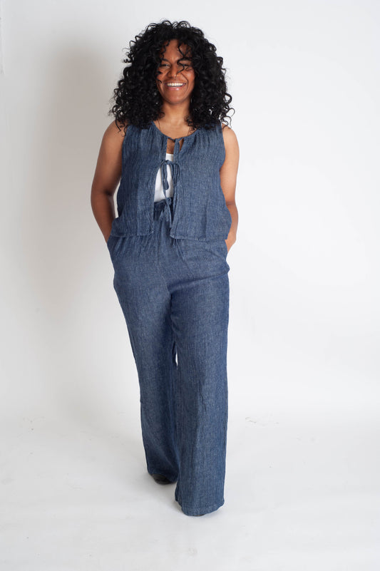 Woman wearing a blue matching set on a white background