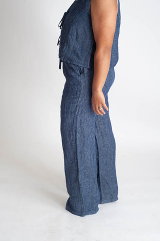 Person wearing a blue jumpsuit on a white background