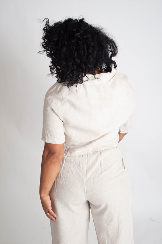 Person wearing a white outfit with a plain background