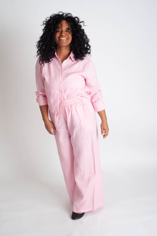 Person wearing a pink matching set on a white background