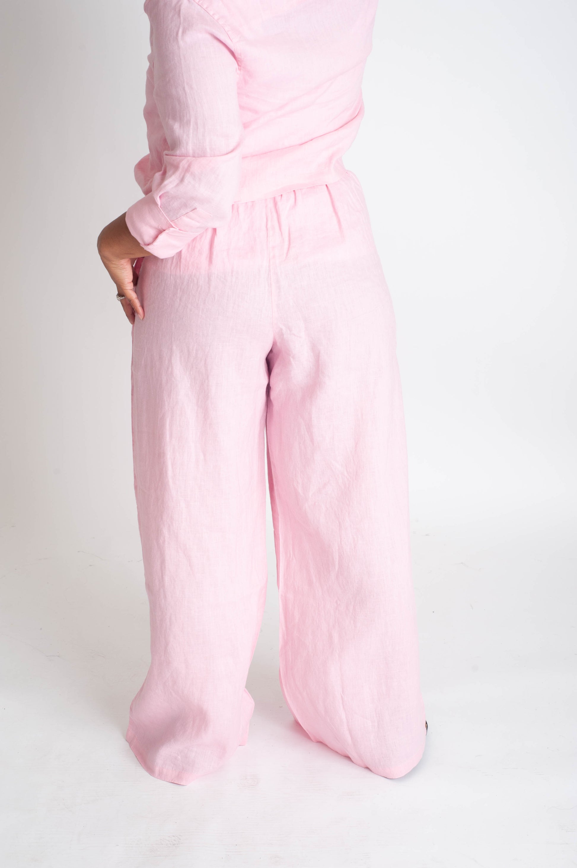 Person wearing pink pants on a white background