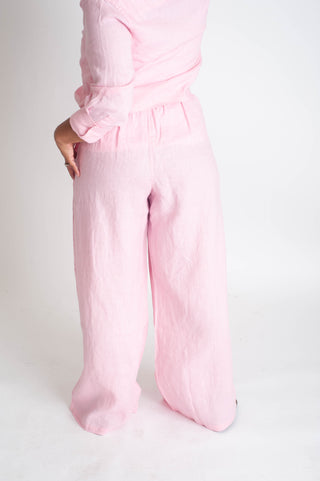 Person wearing pink pants on a white background