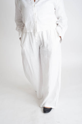 Person wearing a white outfit on a plain background