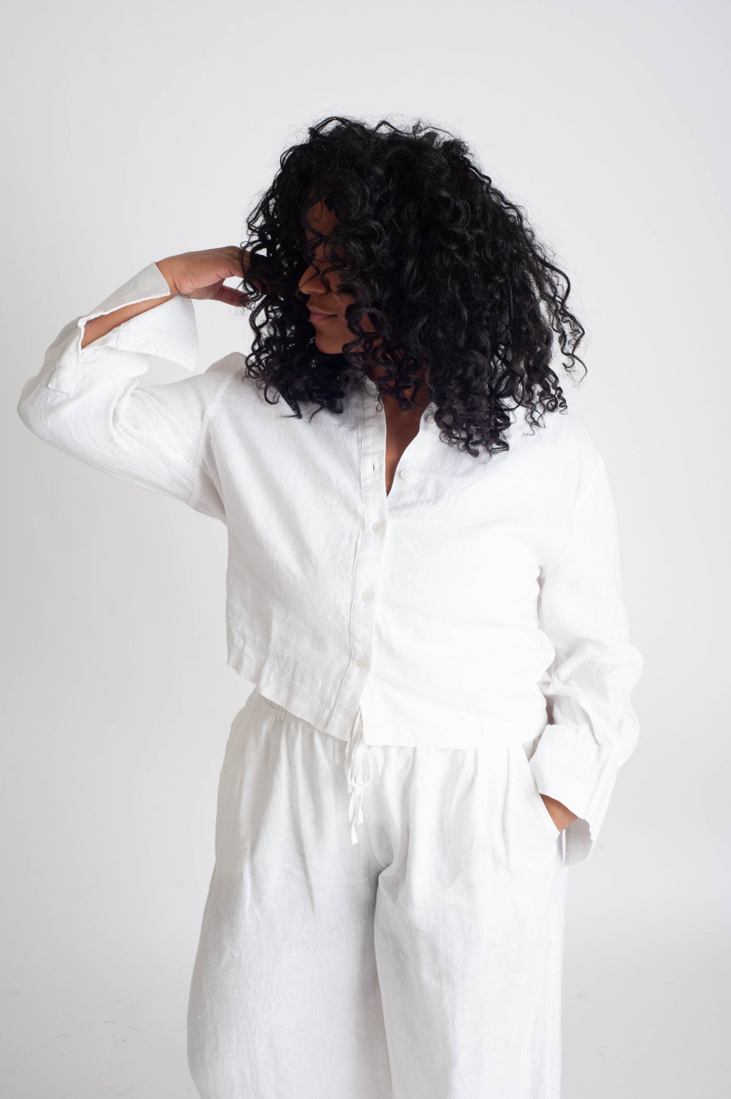 Person wearing a white outfit on a plain background