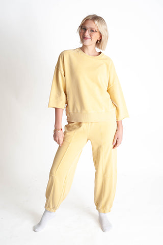 Person wearing a yellow outfit on a white background