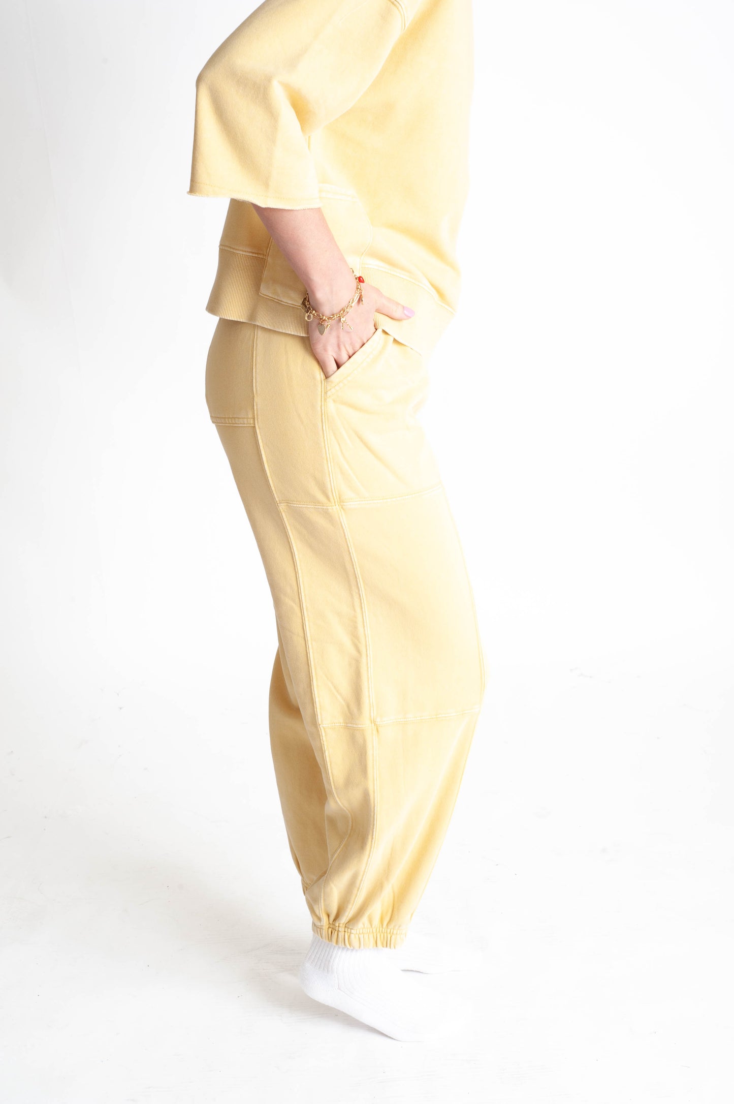 Person wearing a yellow outfit with a white background