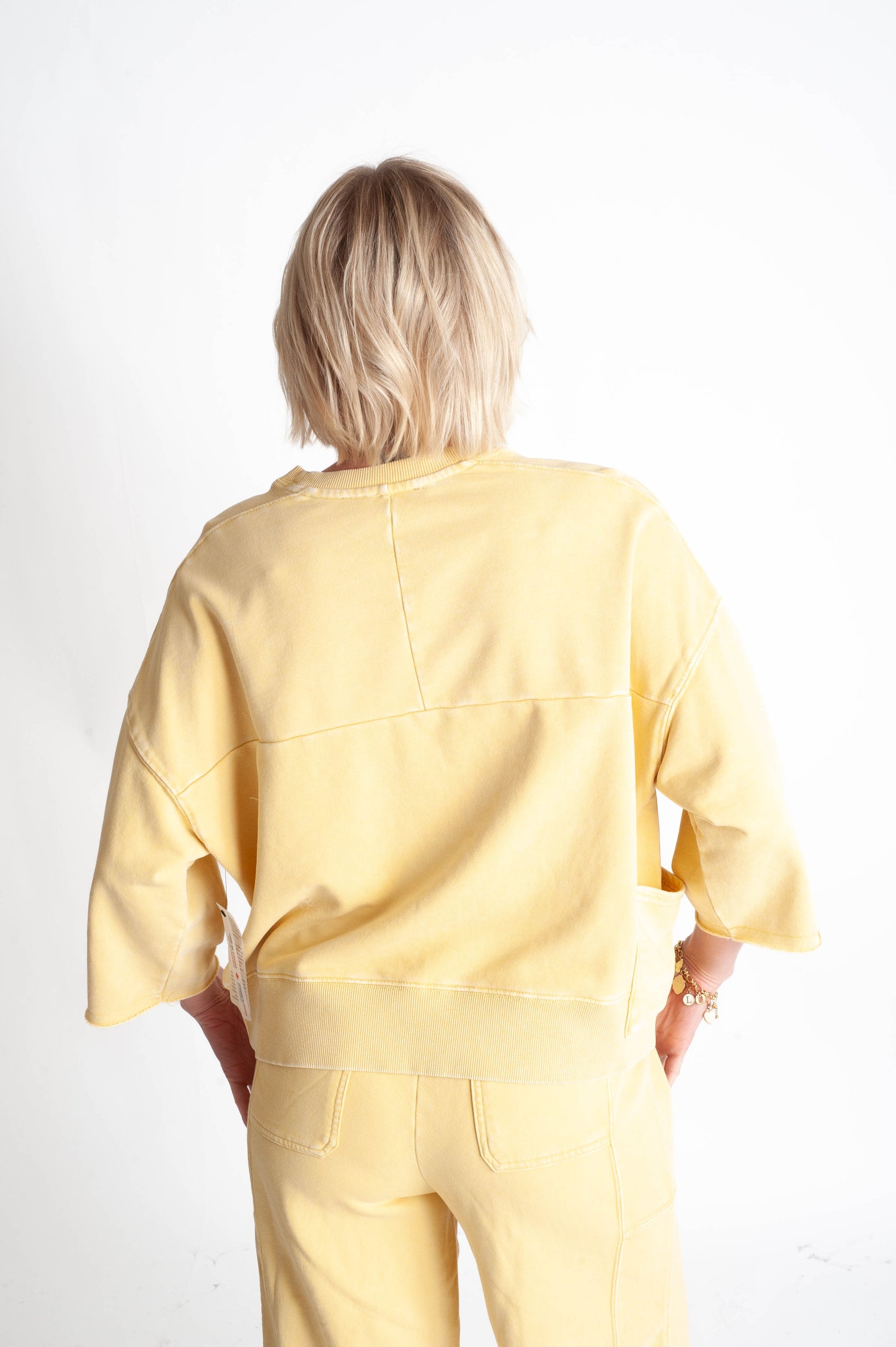 Person wearing a yellow outfit on a white background