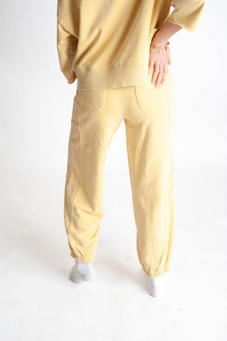 Person wearing a yellow outfit on a white background