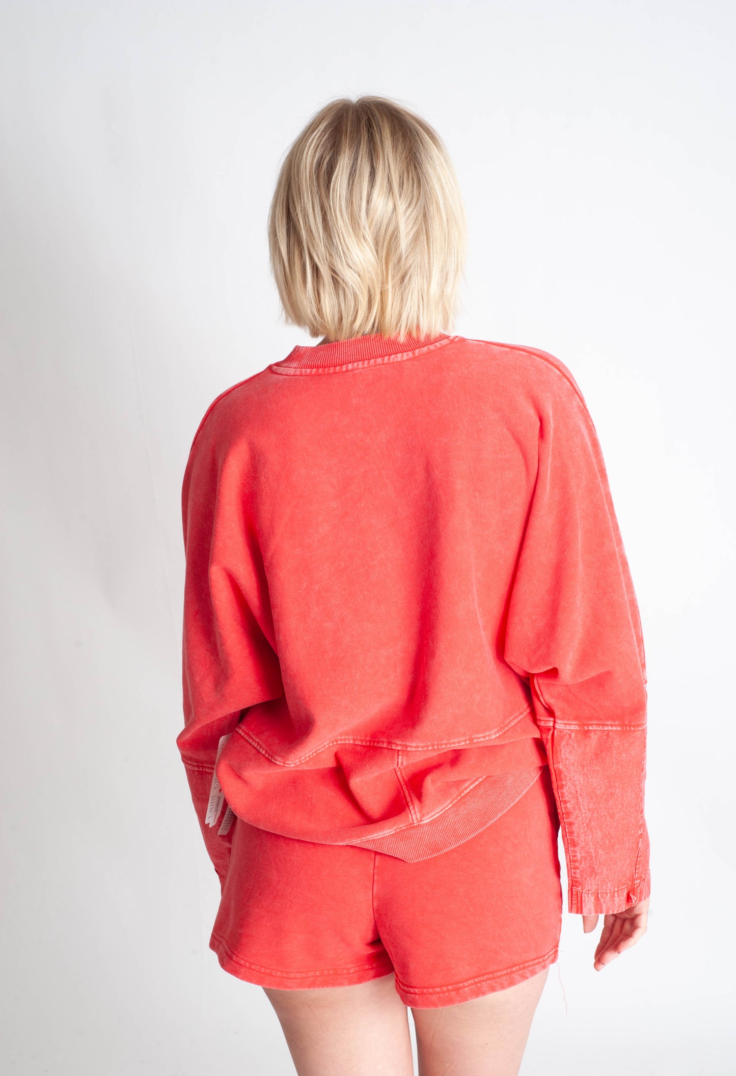 Person wearing a red outfit with a plain background
