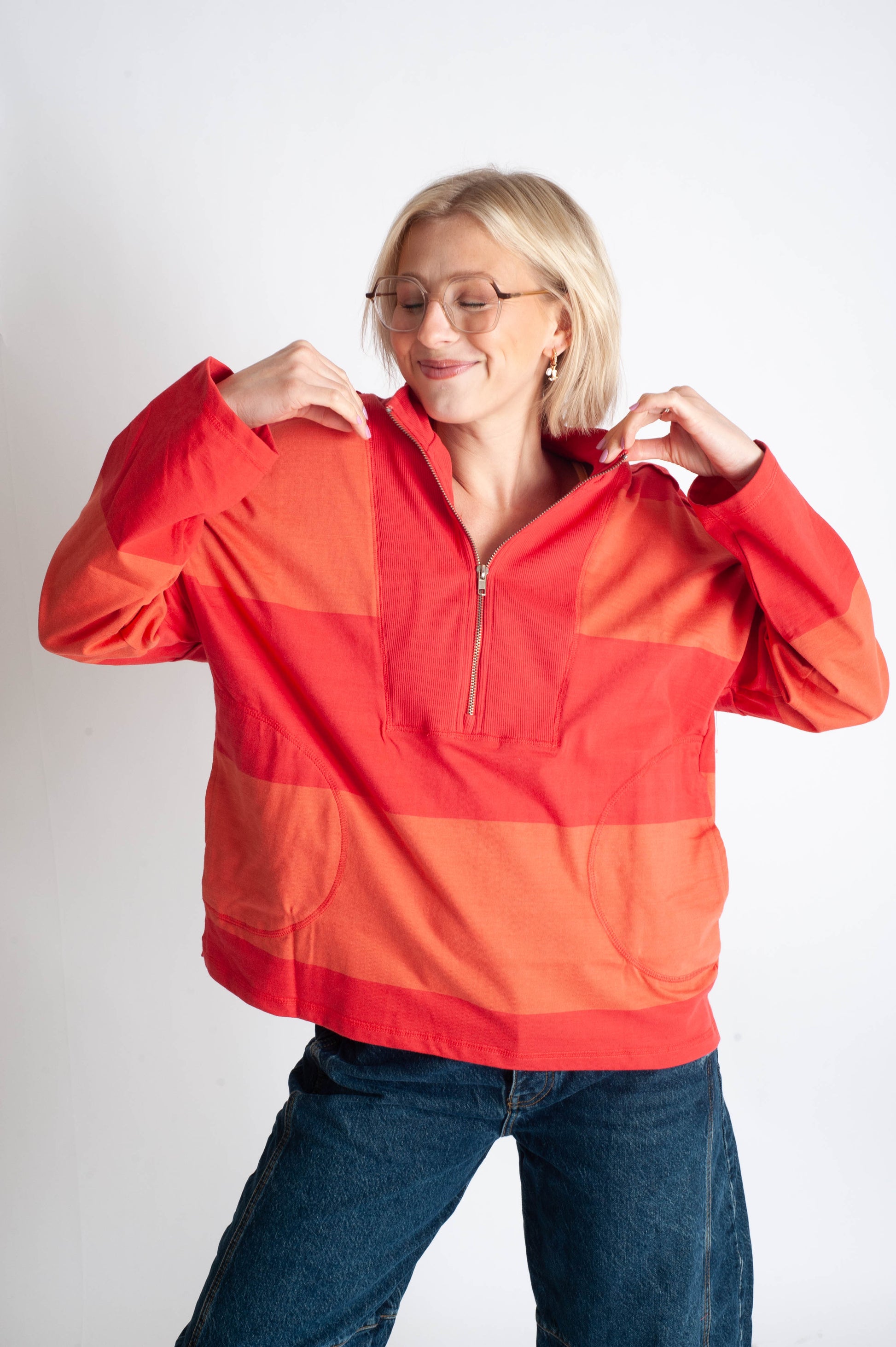 Person wearing a red and orange checkered jacket on a white background