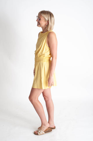 Woman wearing a yellow dress on a white background