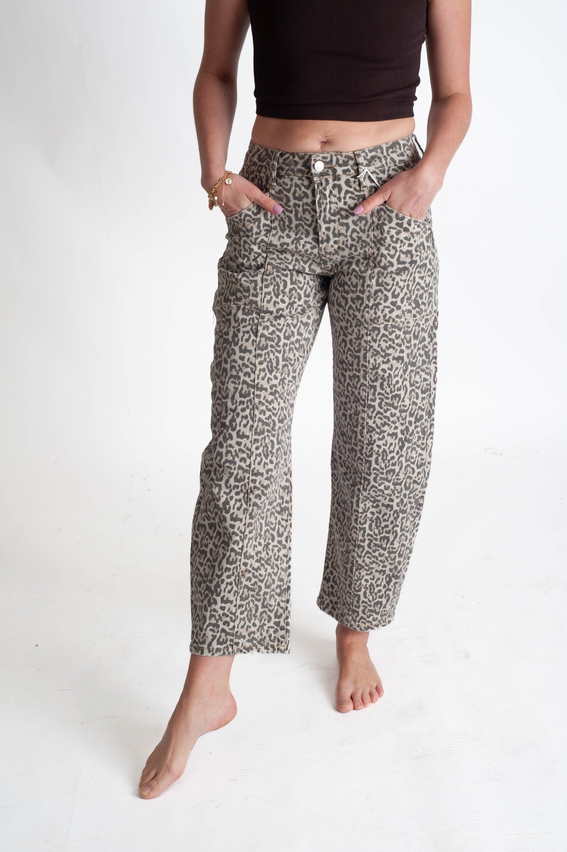 Person wearing leopard patterned pants on a white background