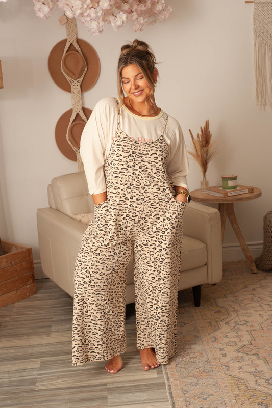 Woman wearing a leopard print dress in a cozy living room.