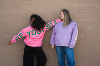 women wearing matching sweaters that say "Be Yourself" on it!