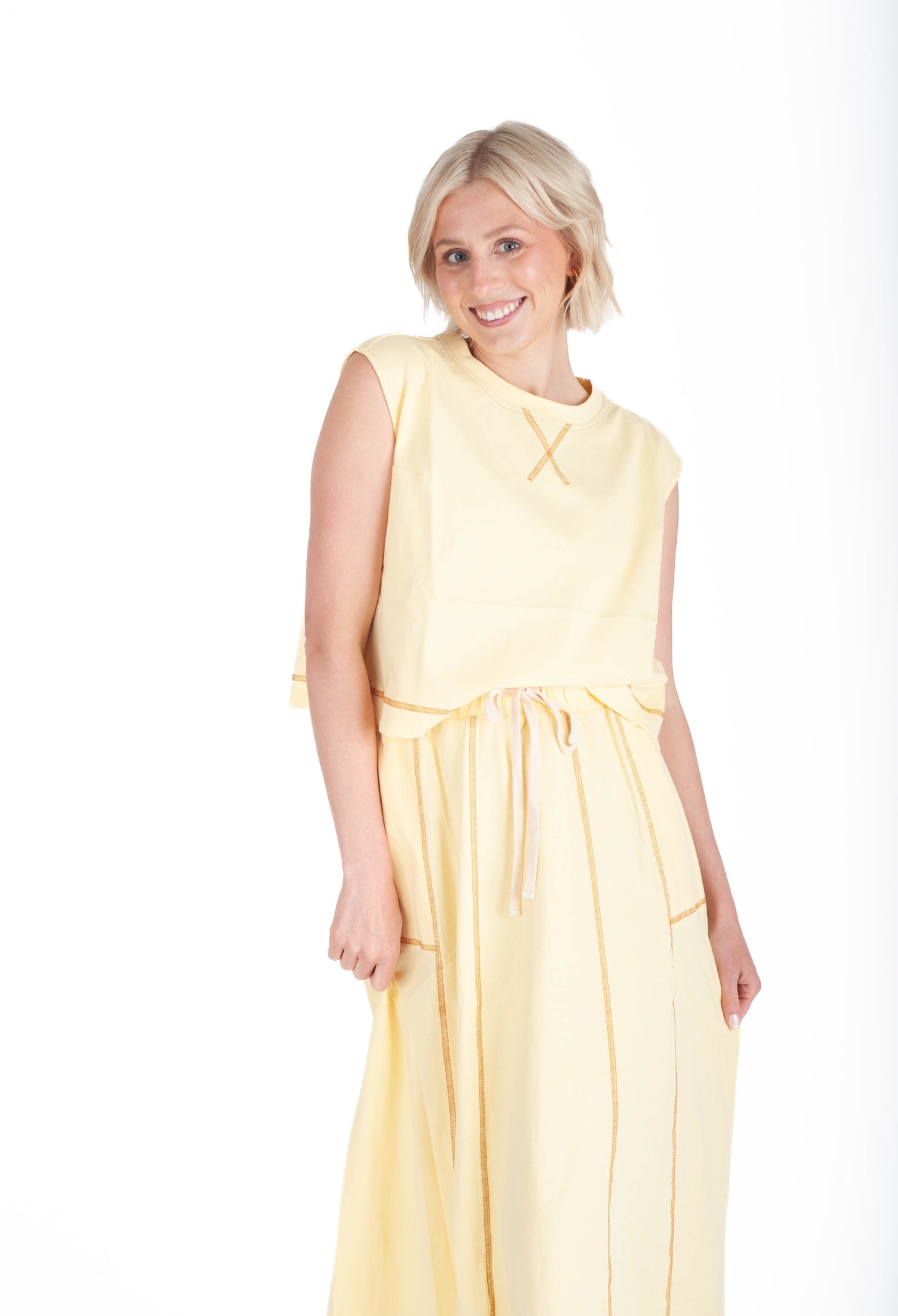 Woman wearing a yellow dress on a white background