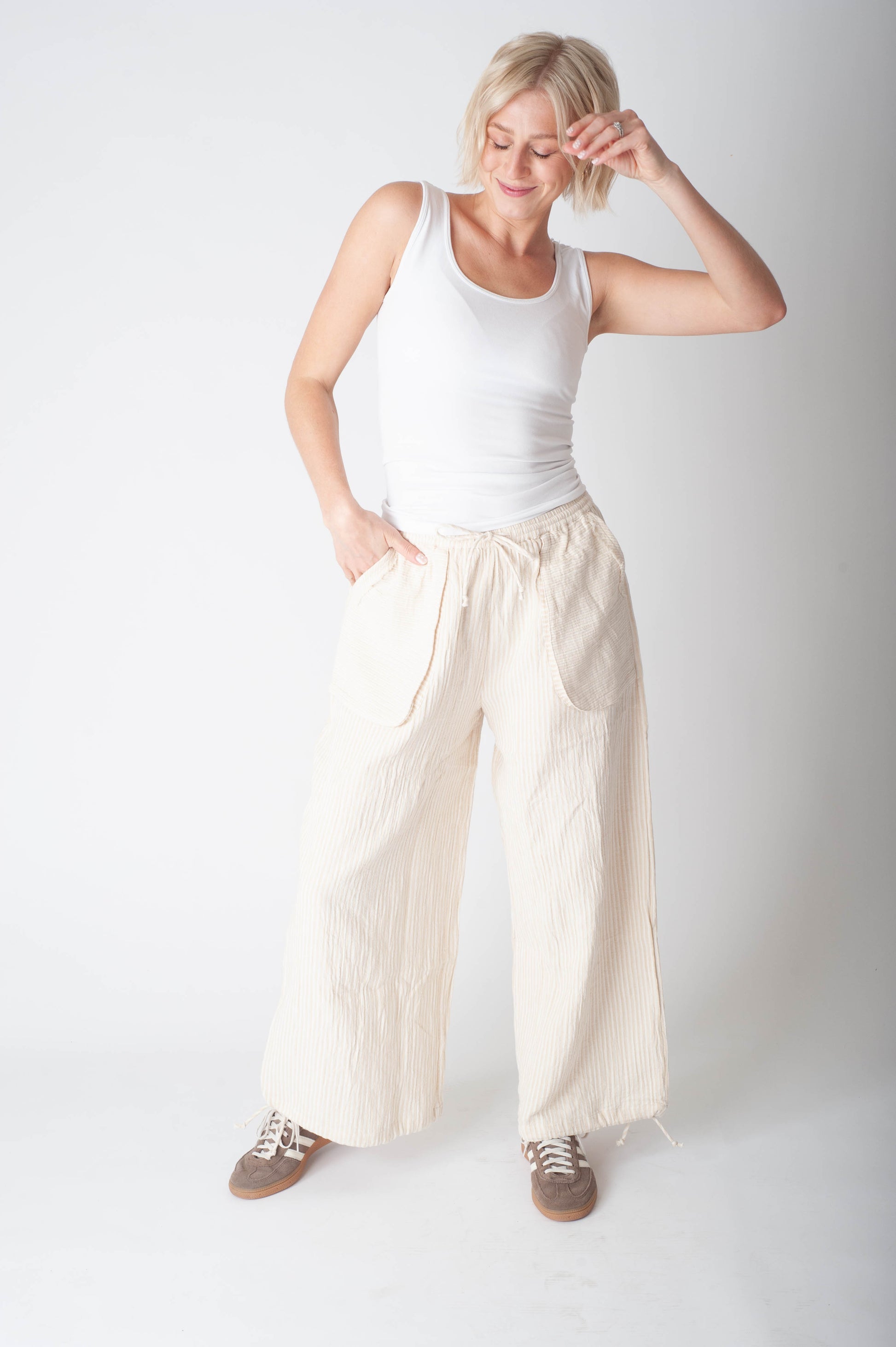 Women wearing a stripe cotton pant and a white tank top. 