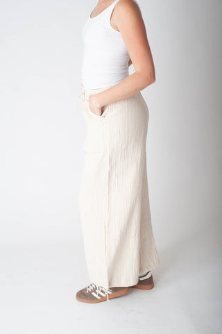 Women wearing a stripe cotton pant and a white tank top. 