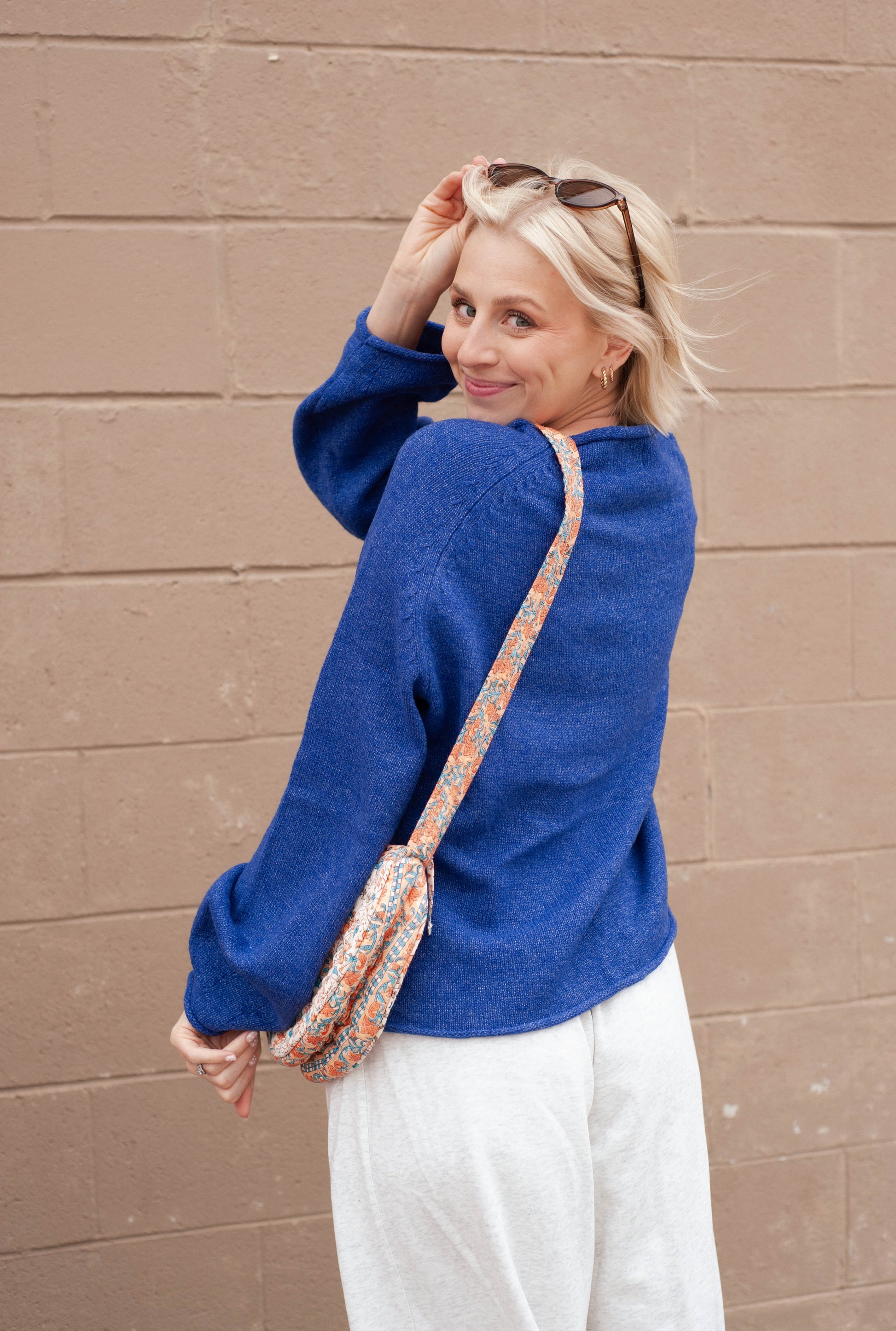 Women wearing a blue sweater with a duck print on it. 