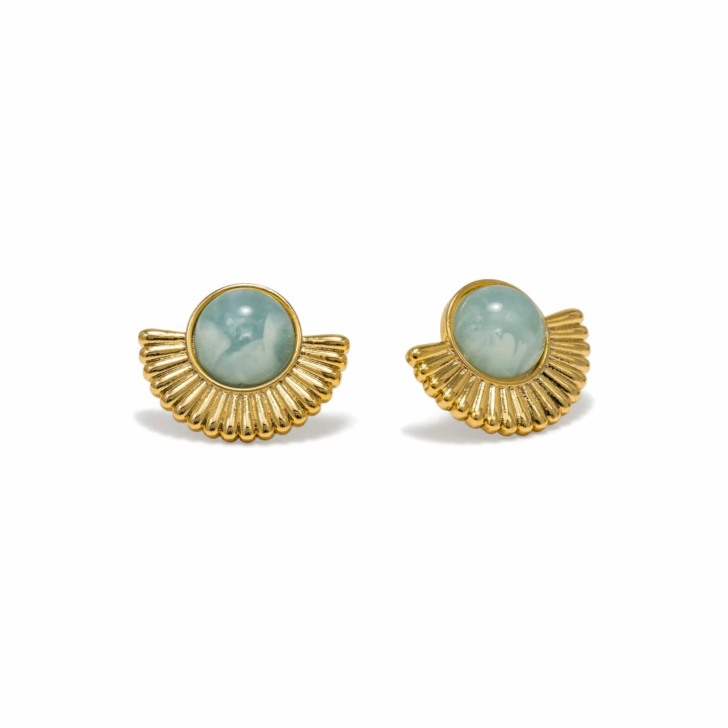 Pair of gold-framed earrings with green gemstones on a white background