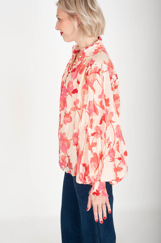 Woman wearing a floral blouse with a white background