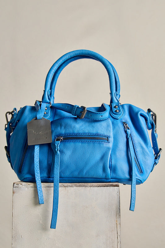 Blue handbag with a tag on a beige background