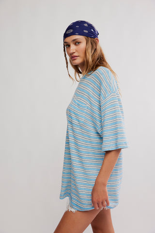 Woman wearing a blue and white striped shirt and a blue bandana on a white background