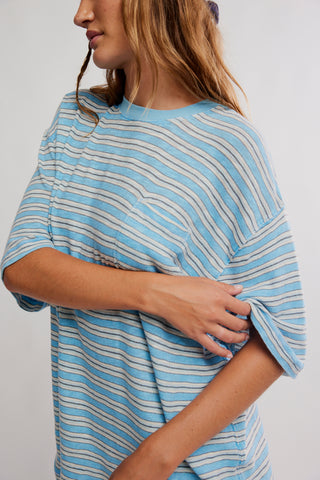 Woman wearing a blue and white striped shirt against a plain background