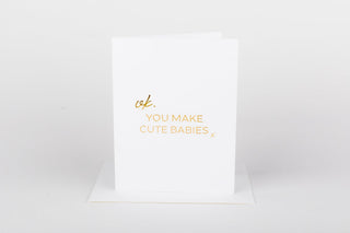 White card with gold text on a white background