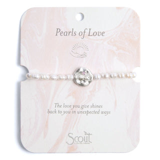 Pearl bracelet on a 'Pearls of Love' Scout branded card with shell charm.