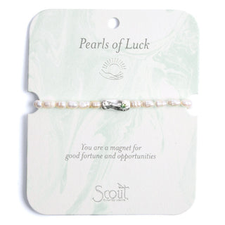 Pearls of Luck bracelet on a Scout branded card with text and logo.