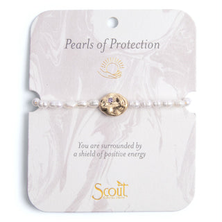 Pearl bracelet with gold charm on a 'Pearls of Protection' Scout branded card.