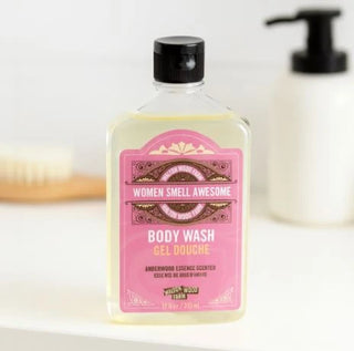 Body wash bottle with pink label on a white surface