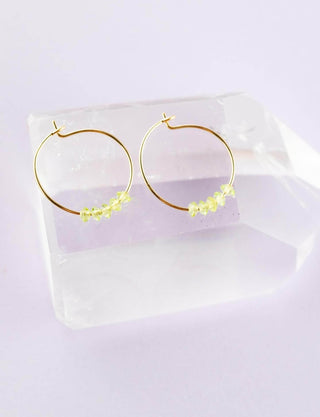 a pair of green crystal hoop earrings 