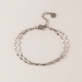 Silver chain bracelet on a light beige background