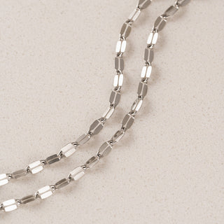 Silver chain on a beige background