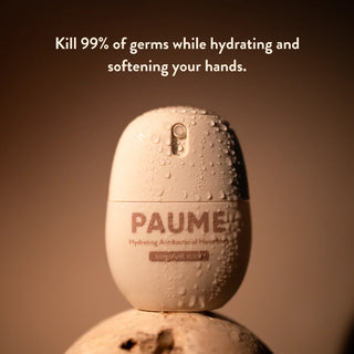 PAUMER hand sanitizer bottle with text on a brown background