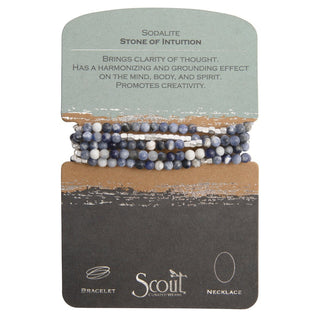 A Sodalite bracelet with a mix of blue and white semi-precious stone beads, presented on a card with the text 'Stone of Intuition has a harmonizing and grounding effect. Promotes creativity.