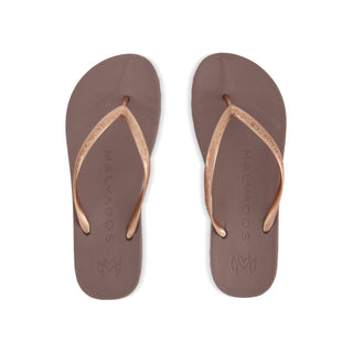 Pair of brown flip-flops with rose gold straps on a white background