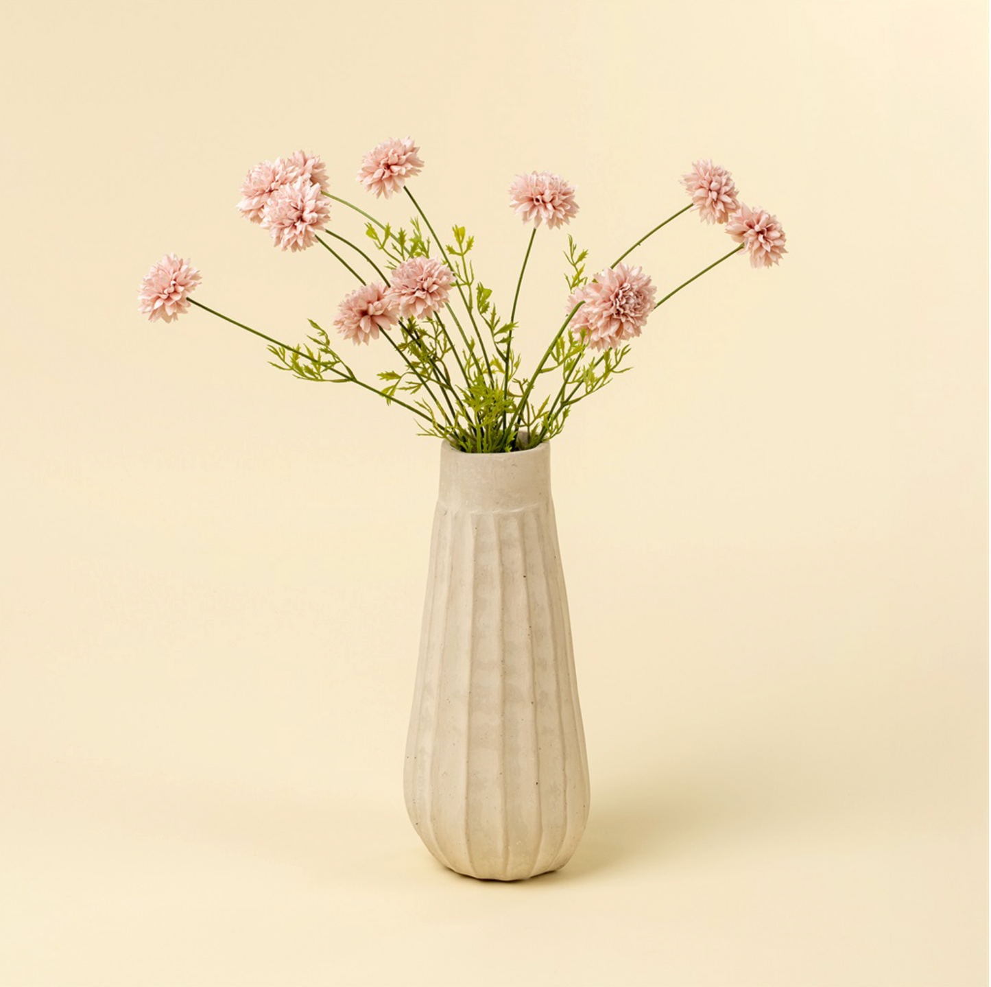 White vase with pink flowers on a beige background