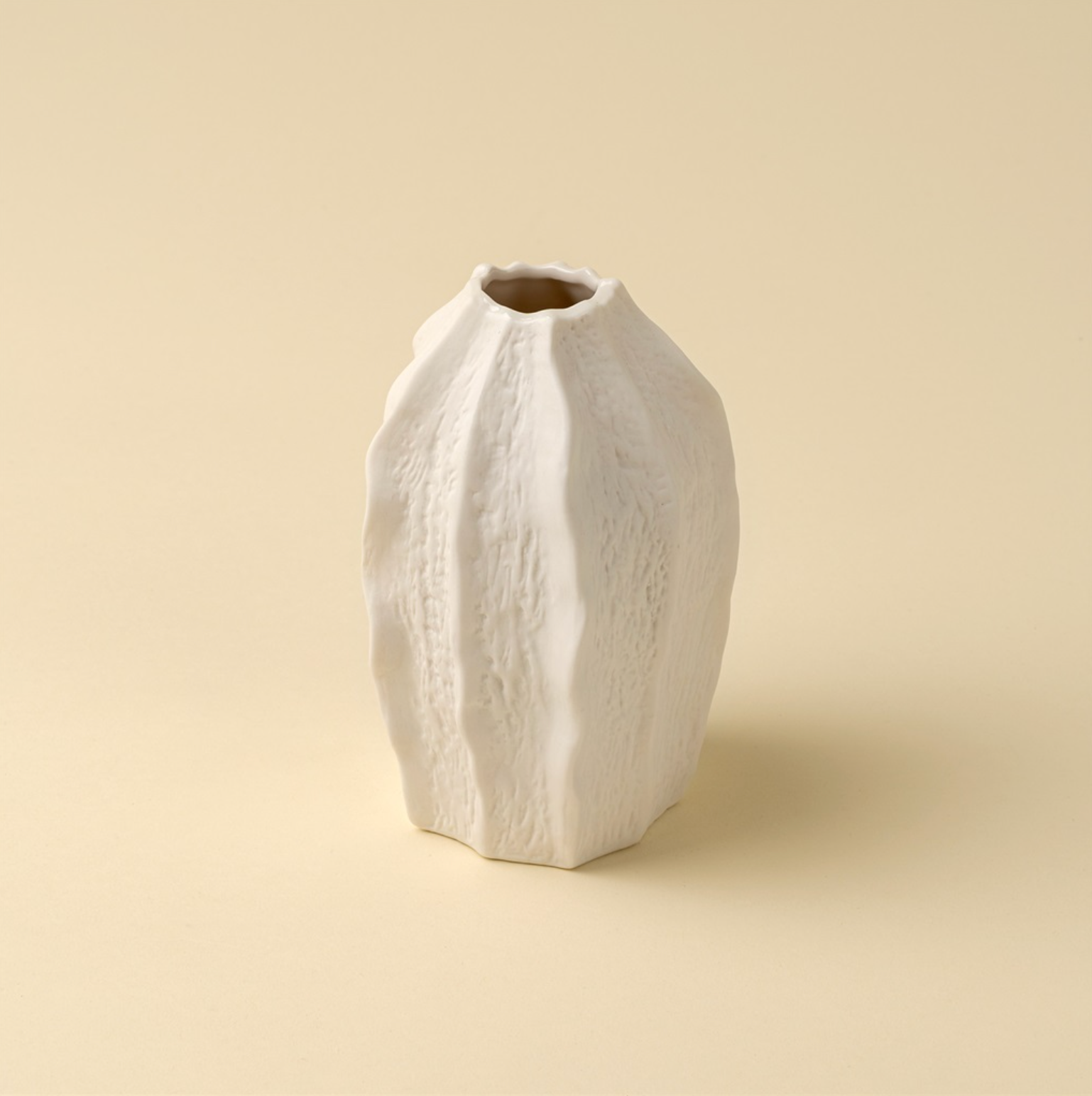 White textured vase on a beige background