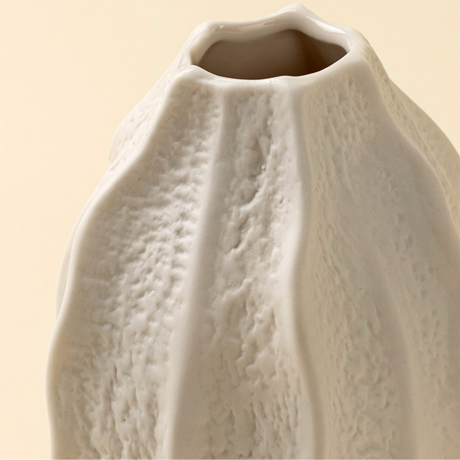 Textured ceramic vase on a beige background