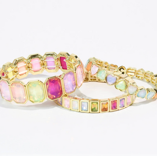 A bright colourful bracelet stack.