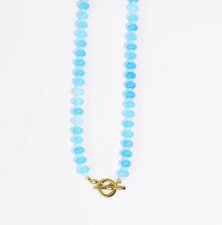 A blue beaded necklace against a white background.