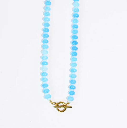 A blue beaded necklace against a white background.