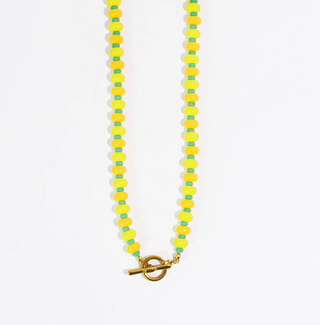 A Yellow & Green beaded necklace against a white background.