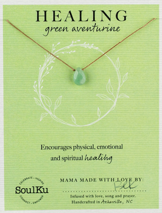 Necklace with green aventurine stone on a green card with text about healing properties, brand 'SoulKu' visible.