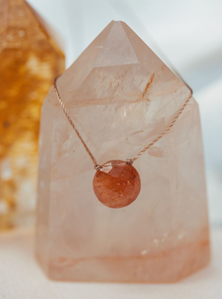 Necklace with a round pendant on a crystal base