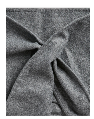 A close-up of a gray heathered fabric, likely wool or felt, gathered and tied in a knot to show its texture and drape.