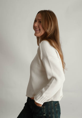 Women modelling a funnel neck sweater against a neutral photo back drop.