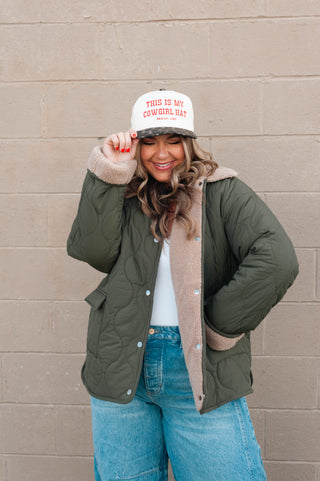 women wearing an embroidered trucker hat saying "this is my cowgirl hat"